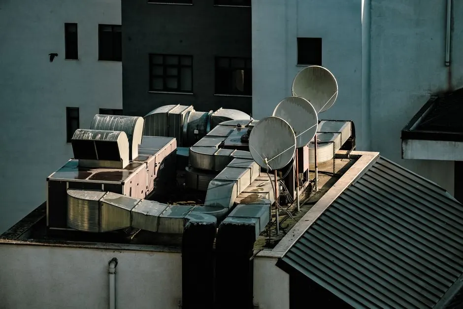 Aerial view of an urban rooftop in Istanbul featuring satellite dishes and ventilation units.